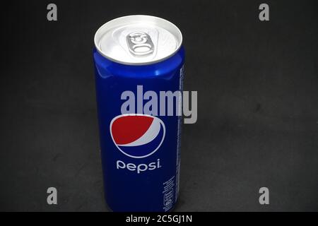 A can of blue pepsi against isolated black background Stock Photo