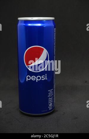 A can of blue pepsi against isolated black background Stock Photo