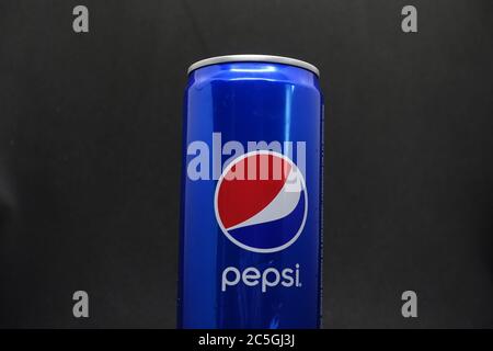 A can of blue pepsi against isolated black background Stock Photo