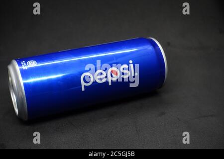 A can of blue pepsi against isolated black background Stock Photo