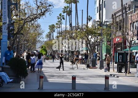 Santa Monica, CA/USA - April 11, 2019: People enjoying the popular Third Street Promenade in Santa Monica on a beautiful summer day Stock Photo