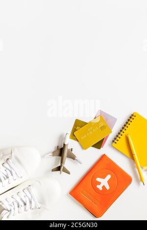 Tavelling background - airplane, shoes, notebook, passport - on white table from above copy space Stock Photo