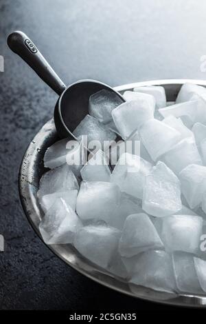 Cold ice cubes in metal bowl. Stock Photo