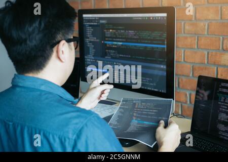 Developing programming and coding technologies working in a software engineers developing applications together in office. Stock Photo