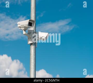 Security CCTV camera against blue sky Stock Photo