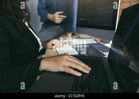 Professional development programmer cooperating meeting programming website working a software in office room. Stock Photo