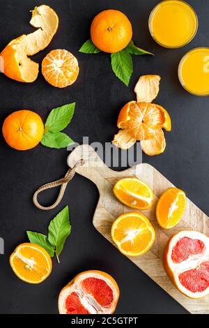 Citrus juice grapefruit slices on cutting board Stock Photo