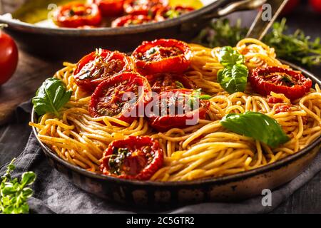 Italian pasta spaghetti with roasted tomatoes basil oregano and