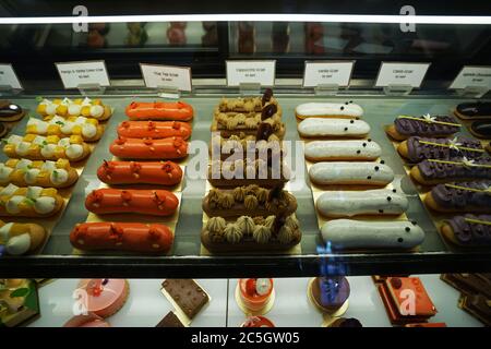 Assorted flavor colorful eclair and French pastry bakery displayed in glass showcase box Stock Photo