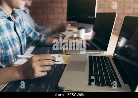Professional development programmer cooperating meeting programming website working a software in office room. Stock Photo