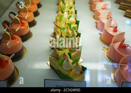 Assorted flavor colorful eclair and French pastry bakery displayed in glass showcase box Stock Photo