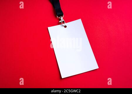 Blank white paper bagde on red background, lanyard mockup Stock Photo