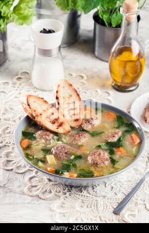 Italian wedding soup with meatballs,  pasta orzo and vegetables. Served in plate Stock Photo