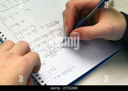 Solving a system equation in high school. Closeup view. Stock Photo