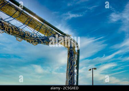 Football goal net against cloudy sky Stock Photo