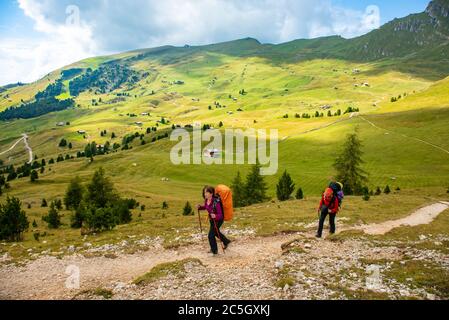Sporty Young women on mountain trail Dolomites Mountains, Italy. Sport, success, inspiration Stock Photo