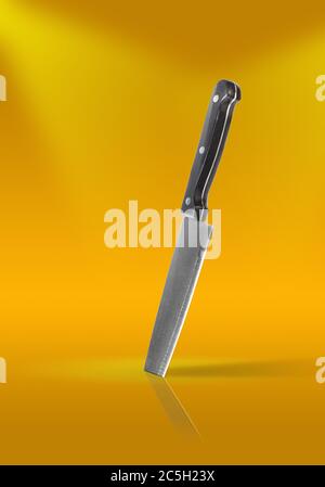 Steel knife planted on a table Stock Photo