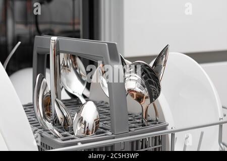Stainless steel cutlery set in drawer. Opened kitchen drawer Stock Photo