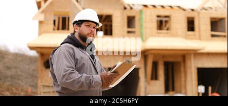 Banner of engineer drawing plan in notebook at construction site. Stock Photo