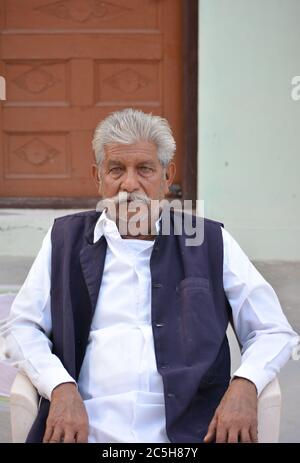 TIKAMGARH, MADHYA PRADESH, INDIA - NOVEMBER 15, 2019: Old indian man portrait shot outside. Stock Photo