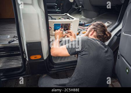 Man working on his camper van conversion Stock Photo