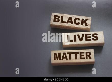 Black lives matter words on Wooden building blocks on black background. Stop racism concept Stock Photo