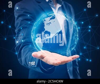 Businessman Holding Hologram Of World Globe Over Blue Background, Cropped Stock Photo