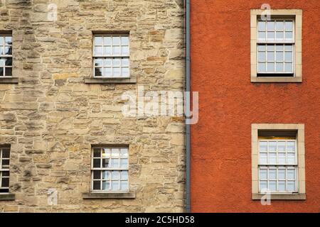 Exterior of a building in Edinburgh, Scotland, focusing on the windows and contrasting colour of adjacent buildings Stock Photo