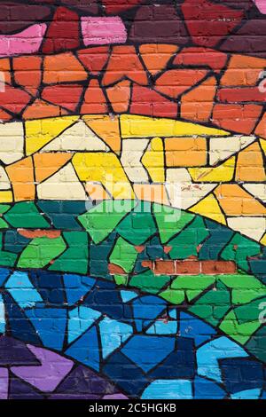 MONTREAL CANADA AUGUST 20 2014: Street art and graffiti. This rainbow mosaic is painted on a brick wall in the gay quarter of Montreal and signifies g Stock Photo