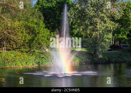 Green park at summer time in Riga Old Town during sunset time. Stock Photo