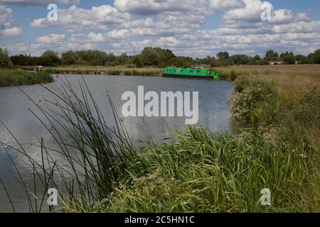 A narrowboat on the Thames River at Farmoor in West Oxfordshire in the English countryside Stock Photo