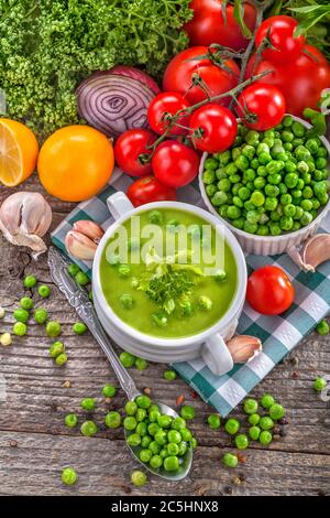 Homemade potage soup made from healthy peas with vegetable decoration. Stock Photo