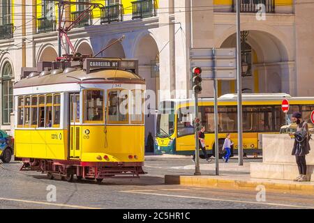 Lisbon, Portugal - March 27, 2018: Yellow tram, symbol of Lisbon and downtown square Stock Photo