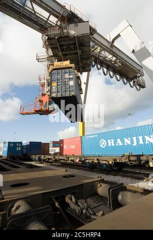 Gantry cranes used to load and unload cargo containers from ships are ...