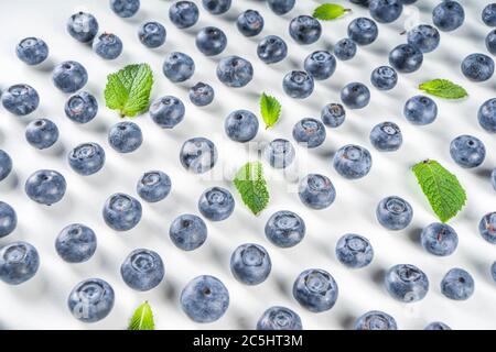 Flatlay pattern with fresh ripe blueberries on white background Stock Photo