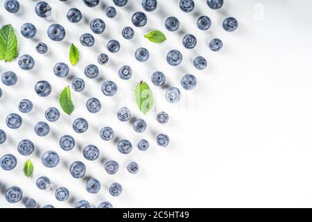 Flatlay pattern with fresh ripe blueberries on white background Stock Photo