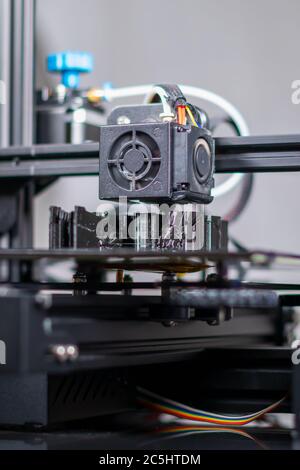 3D plastic printer during work in a factory three dimensional printing. Close-up detail. Stock Photo