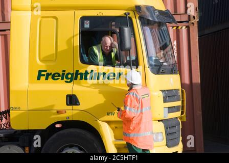 Freightliner lorry driver speaking with a colleague at Manchester Euroterminal, Trafford Park, Manchester, England. Stock Photo