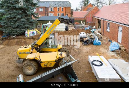 BUCKINGHAM, UK - December 02, 2016. Building work, construction site with heavy machinery on a heritage house renovation project, UK Stock Photo