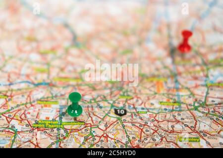 Very shallow focus of a green push pin located in the famous North London area of Wembley. Stock Photo