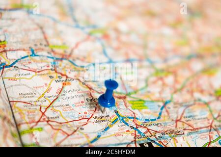 Very shallow focus of a blue push pin located at Virginia Water. Located outside London, the area has some of the most expensive private properties. Stock Photo