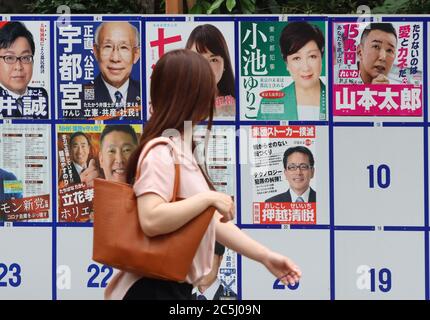 Tokyo, Japan. 3rd July, 2020. A woman checks candidates for the Tokyo gubernatorial election on a board in Tokyo on Friday, July 3, 2020. Tokyo gubernatorial election will be held on July 5. Credit: Yoshio Tsunoda/AFLO/Alamy Live News Stock Photo