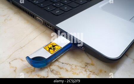 Infecting a laptop with a Computer Virus via usb stick, free copy space Stock Photo