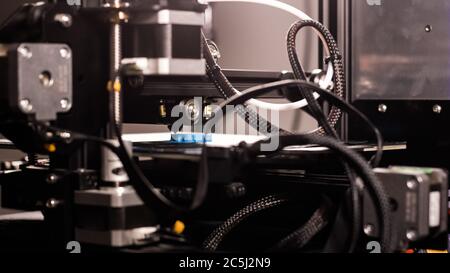 3D plastic printer during work in a factory three dimensional printing. Close-up detail. Stock Photo