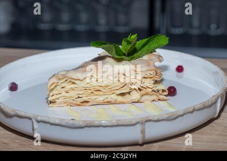Celebratory cakes on a plate. Tubules and cake for birthday and other holidays. In the bar. Foreground. Stock Photo