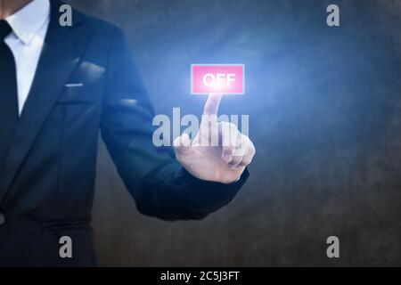 Businessman pressing OFF button icon. Concept of technology and business. Stock Photo