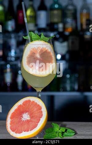 Refreshing summer cocktails with a slice of lime. Alcoholic drink. Garnished with a sprig of mint, citrus and ice cubes. In the bar. Foreground. Stock Photo