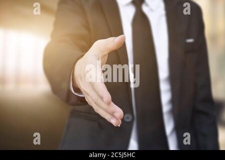 Businessman offering his hand for handshake in office. Concept of welcome for collaboration, introduction. Selective focus. Stock Photo