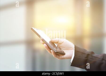 Closeup of businessman hand using mobile smartphone. Idea for business and technology. Stock Photo