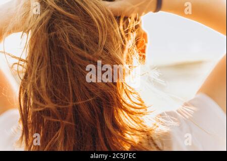 Girl looks at the sunset on the sea from the deck of a cruise boat. Corsica, mediterranean sea Stock Photo